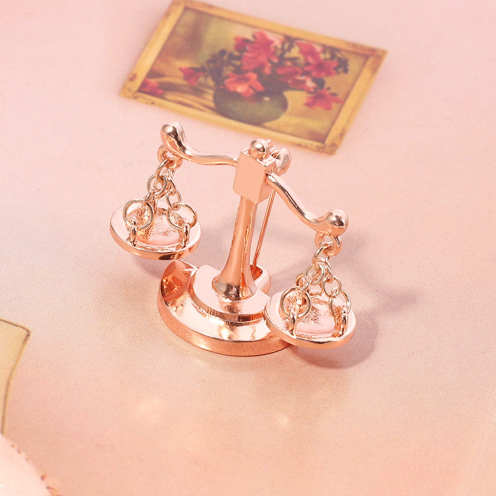 Valenedit | Balance Pin, Crafted in zinc alloy with a rose gold–tinted finish